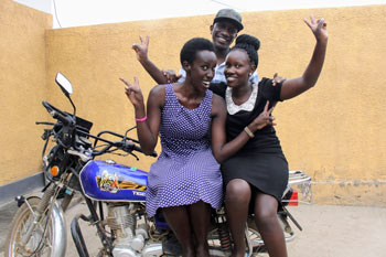 A group of 3 Fellows pose on their motorcycle
