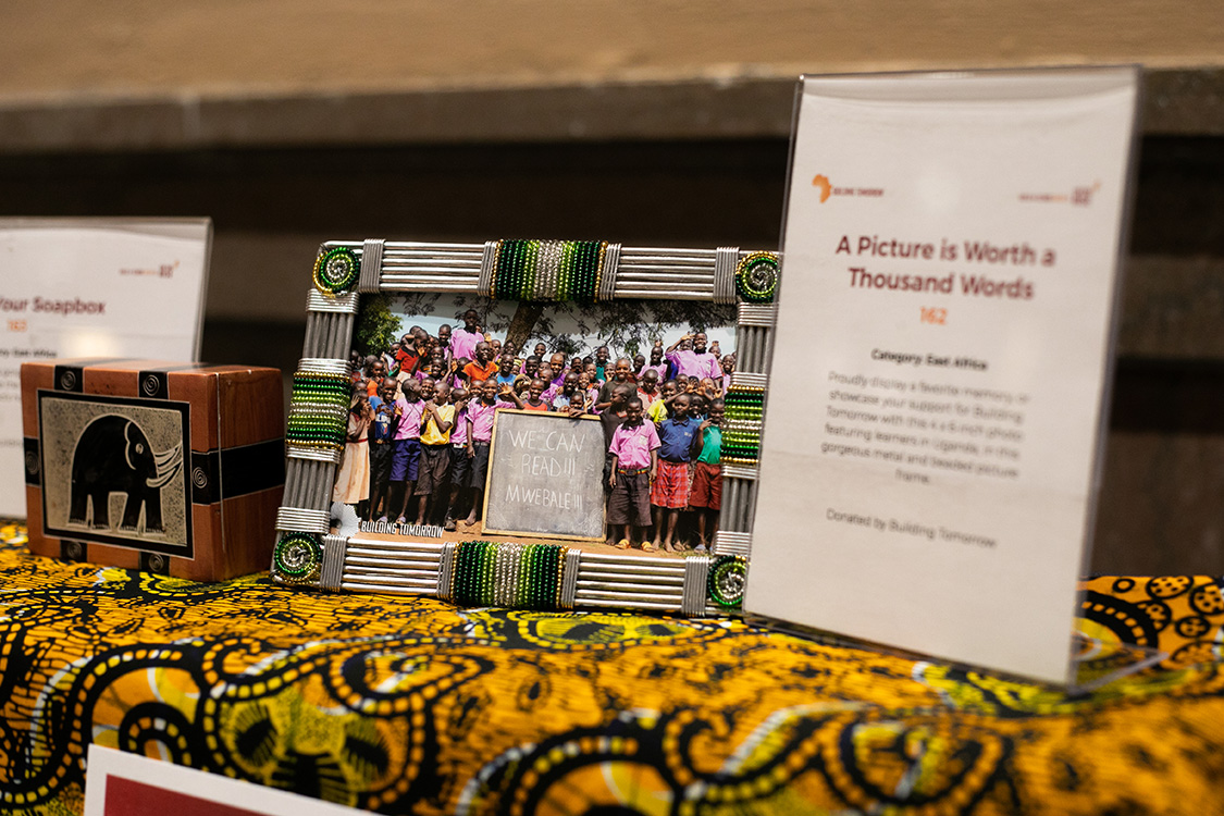A framed photo of Ugandan schoolchildren sits on the silent auction table