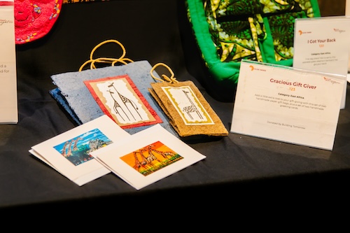 A set of colorful gift bags sit on the silent auction table