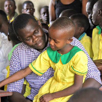 A student sitting on a Fellow's lap