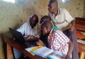 Teachers at the New Eden Primary School in Kamwenge District practice writing their CVs together.